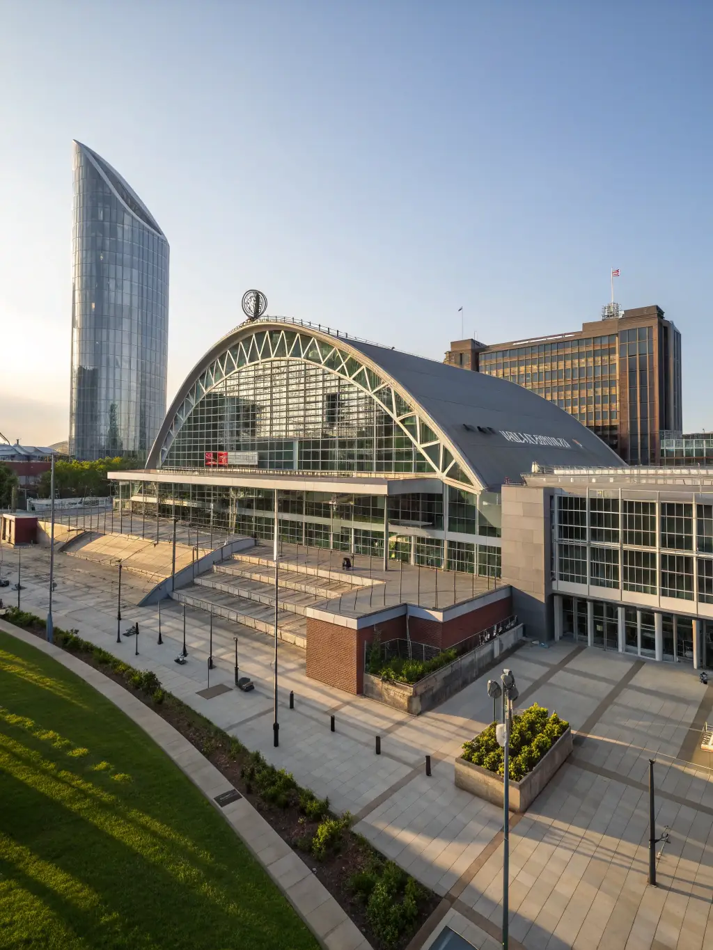 A photograph of the conference venue, the Manchester Central Convention Complex, with a focus on its modern architecture.