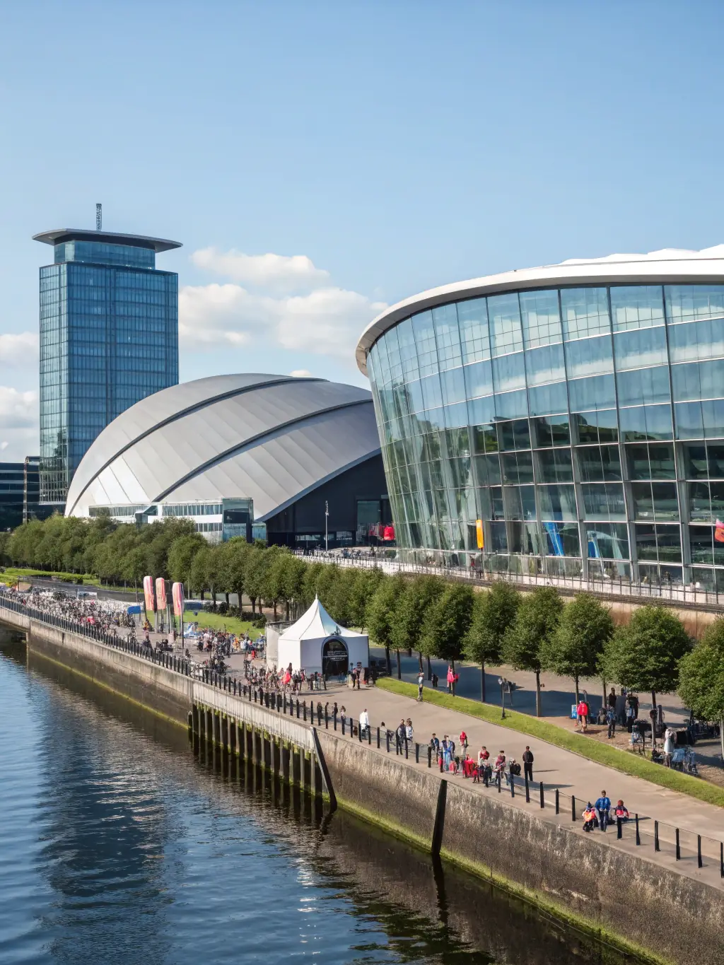 A photograph of the conference venue, the Scottish Event Campus (SEC) in Glasgow, showcasing its waterfront location.