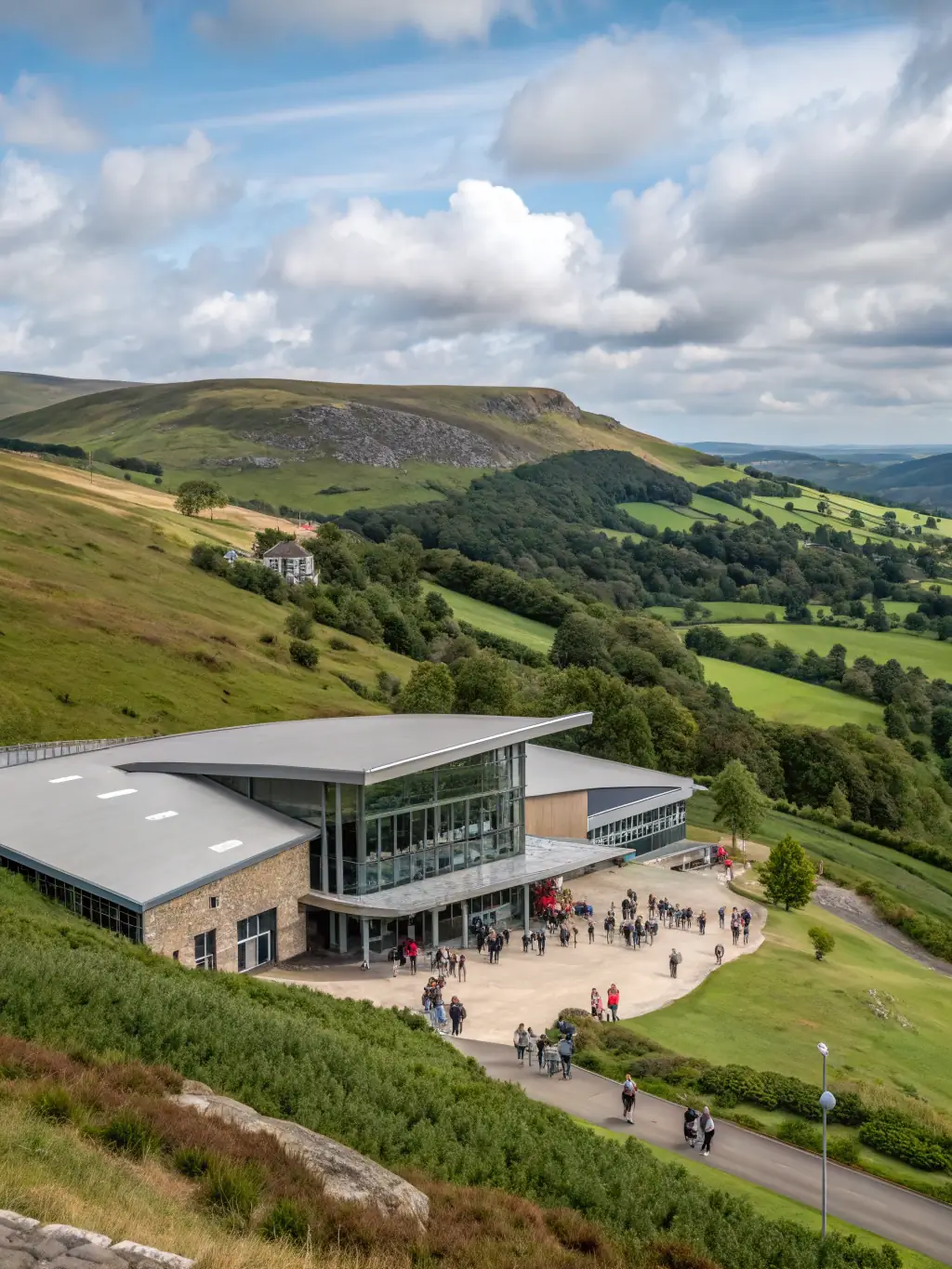 A photograph of the conference venue, the International Convention Centre (ICC) Wales, set against the backdrop of the Welsh countryside.